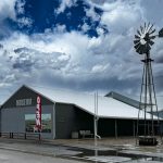 A museum with a windmill and storm clouds in Fort Benton, MT