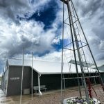 A museum with a windmill and storm clouds in Fort Benton, MT